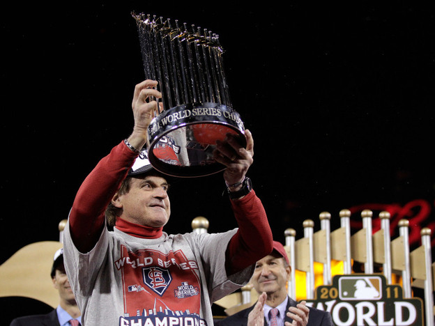 Cardinals manager Tony La Russa celebrated with the World Series trophy Friday night in St Louis.