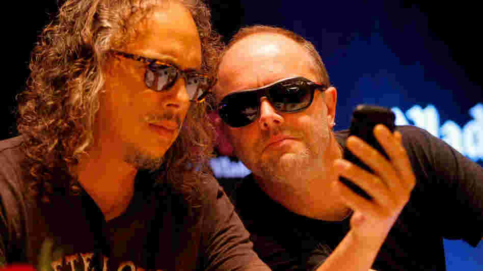 Heads together: We wouldn't want to suggest that Kirk Hammett (left) and Lars Ulrich are actually plotting new strategies for infuriating their loyal followers in this photo. But they do seem to be up to something.
