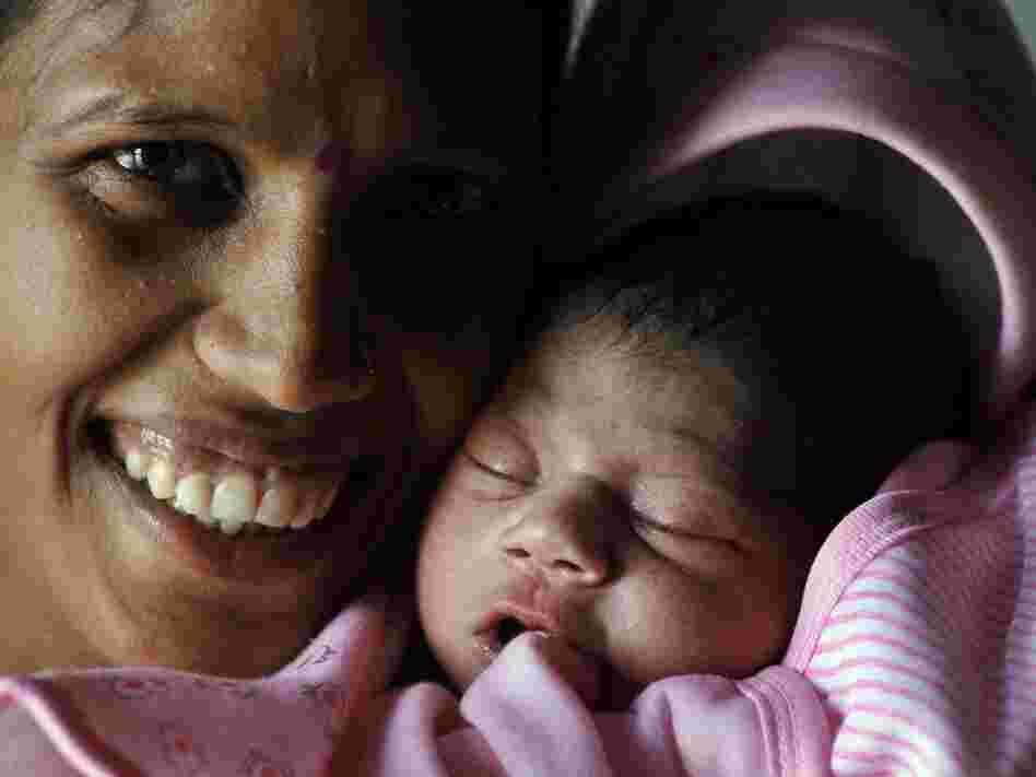 Several babies born today have been deemed the symbolic 7 billionth person — including a little girl named Nargis in Lucknow, India. Here she is with her mother, Vinita.