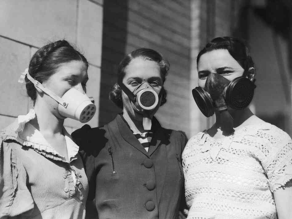 Three girls model Dust Bowl masks to be worn in areas where the amount of dust in the air causes breathing difficulties, circa 1935.