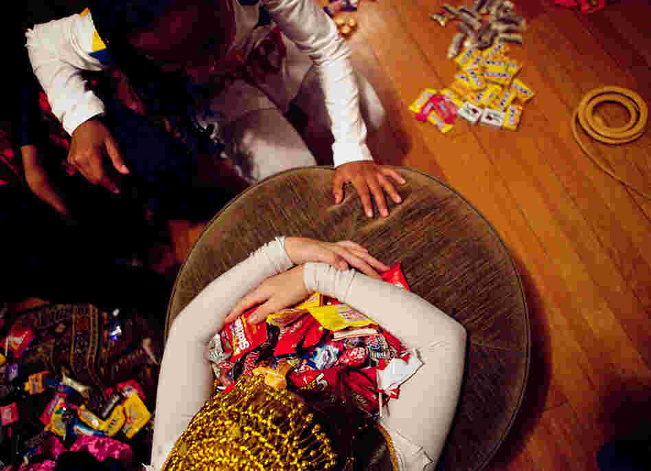 Eden Rose Breslow grabs her loot as Sierra Lewter goes in for a trade after trick-or-treating on Monday. Eden Rose Breslow grabs her loot as Sierra Lewter goes in for a trade after trick-or-treating on Monday.