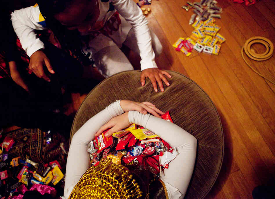 Eden Rose Breslow grabs her loot as Sierra Lewter goes in for a trade after trick-or-treating on Monday. Eden Rose Breslow grabs her loot as Sierra Lewter goes in for a trade after trick-or-treating on Monday.