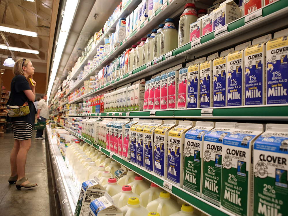 A customer studies a display of milk and dairy products at Bryan's Grocery in San Francisco in March.