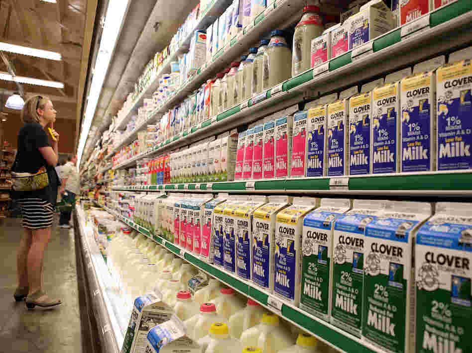 A customer studies a display of milk and dairy products at Bryan's Grocery in San Francisco in March.