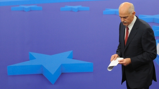 Greek Prime Minister George Papandreou leaves a news conference after a meeting with European Council President Herman Van Rompuy on Oct. 13 at EU headquarters in Brussels. EU leaders were surprised and angered Tuesday when Papandreou said he would place a debt restructuring proposal before Greek voters.