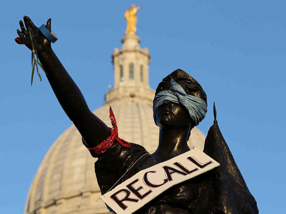 A sign that reads "recall" hangs on a statue in front of the Wisconsin state Capitol last month in Madison. Labor groups are making an effort to recall Gov. Scott Walker for his controversial union rights law. A sign that reads "recall" hangs on a statue in front of the Wisconsin state Capitol last month in Madison. Labor groups are making an effort to recall Gov. Scott Walker for his controversial union rights law.
