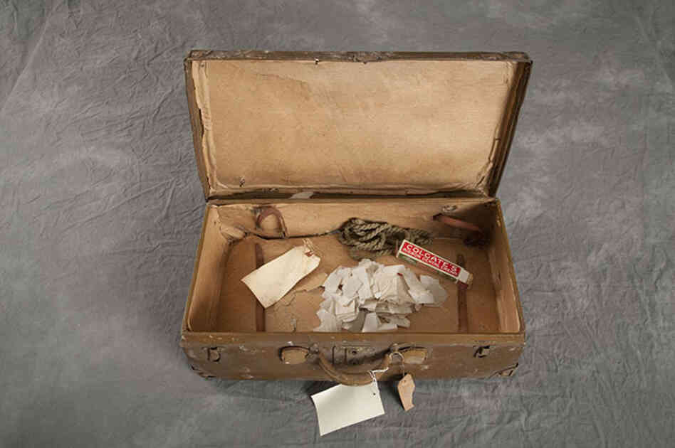 This suitcase, belonging to Raymond H., has a tag that dates it to May 4, 1923.