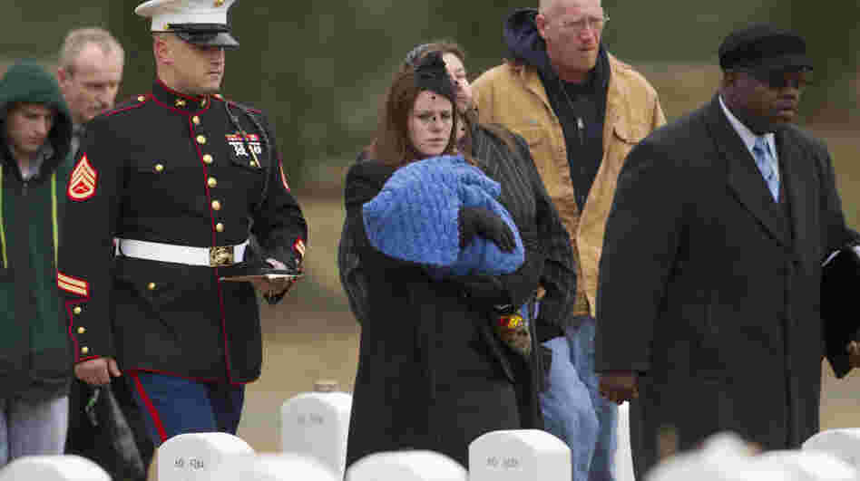 Kait Wyatt carries her 1-month-old son, Michael, at the burial for her husband, Marine Cpl. Derek Wyatt, at Arlington National Cemetery, Jan. 7. Wyatt was killed Dec. 6, 2010, in Afghanistan. Kait Wyatt, who was pregnant at the time of her husband's death, was induced the day after he was killed so she could attend the service.