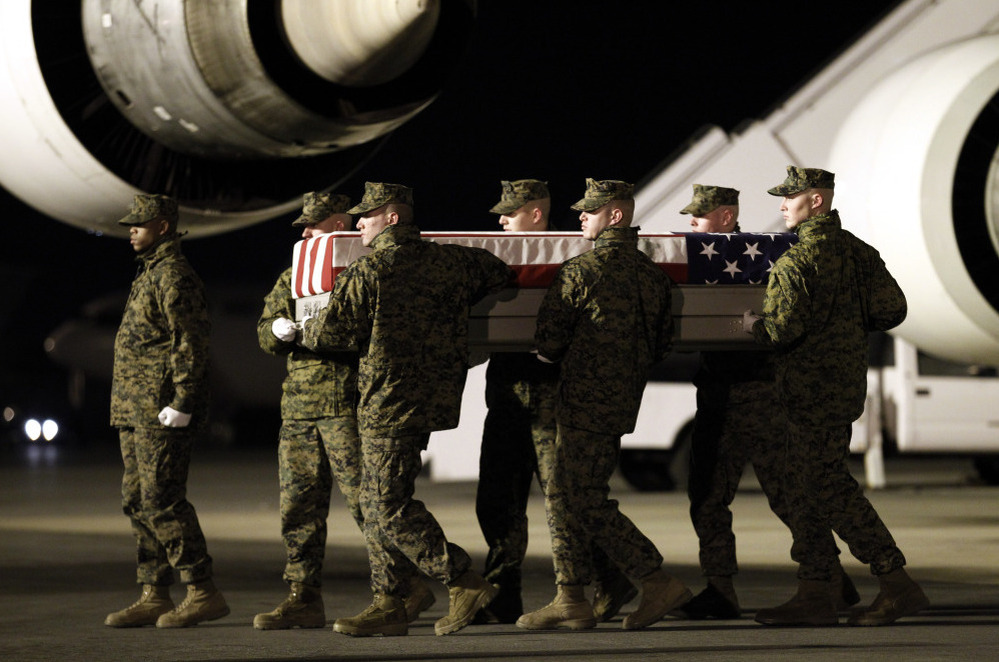 Marines carry the remains of Cpl. Derek Wyatt upon arrival at Dover Air Force Base, Del., on Dec. 8, 2010. He was killed by hostile fire during a deployment to Sangin in southern Afghanistan's Helmand province.
