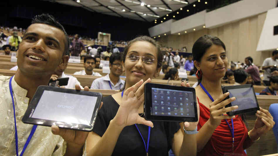 Indian students pose with the supercheap Aakash tablet computers, which they received during the Oct. 5 product launch in New Delhi. The Indian government intends to deliver 10 million tablets to college students across India at a subsidized price of $35.