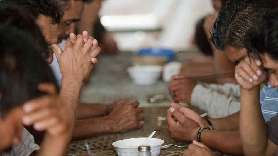 A group of illegal immigrants from Central America deported from the United States eat at a shelter near the Mexico-U.S. border, in Nogales, Sonora, Mexico, July 28, 2010. Last year, the U.S. deported a record number of immigrants — and the Mexican border towns where they are being released face serious problems coping with the influx.