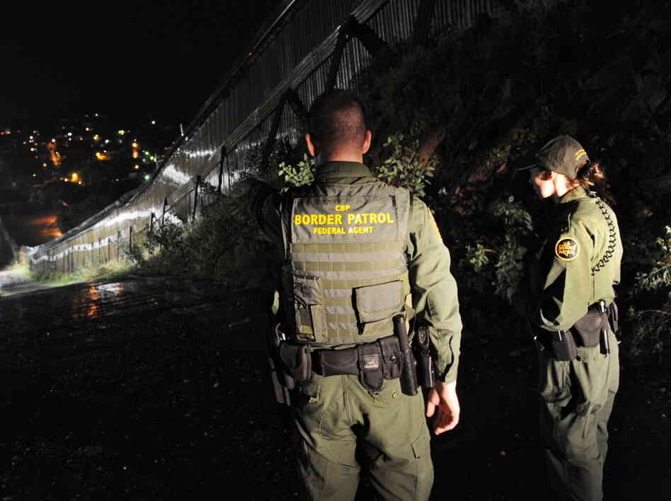 U.S. Border Patrol agents patrol along the border fence between Arizona and Mexico, July 28, 2010. 