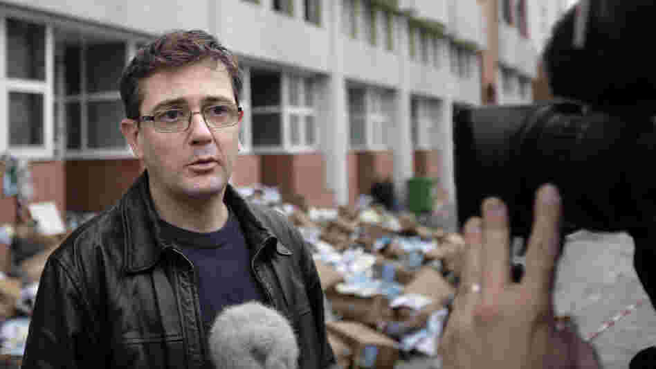 Charlie Hebdo's publisher, known only as Charb, talked to journalists today (Nov. 2, 2011) in front of his publication's burned-out offices. 