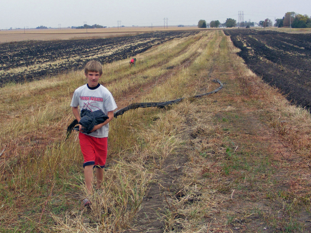 Drew Wilber, 14, works on his parents' 20-acre farm near Boone, Iowa, during his day off from school on Columbus Day. 