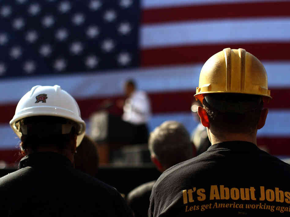 Construction workers listen as President Obama speaks at the Georgetown Waterfront Park in Washington on Wednesday.