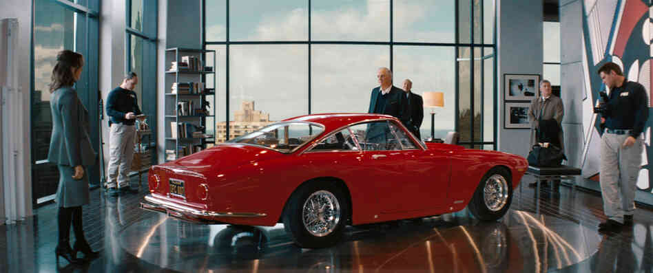 Seeing Red: Alan Alda (center, with Tea Leoni) and the Ferrari he keeps in his luxury-high-rise living room are the targets of both the payback plot and an FBI investigation.