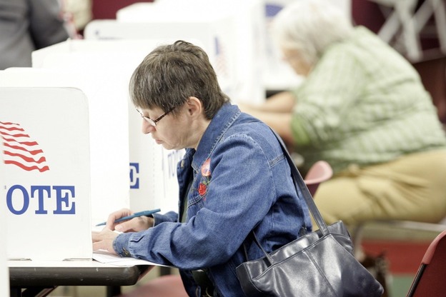 A woman casts her ballot during early voting in Toledo, Ohio. Members of the silent generation are more likely to vote for Republicans than for Democrats, according to a recent study by the Pew Research Center. 