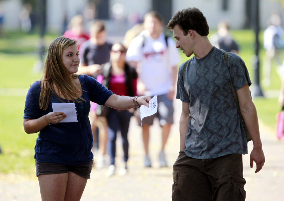 Genna Schwartz (left) of the Ohio State University Student Democrats tried to hand out information about President Obama's Oct. 17 visit to Ohio State and was turned down by a young man. The Obamamania that gripped college campuses two years ago is largely gone. 