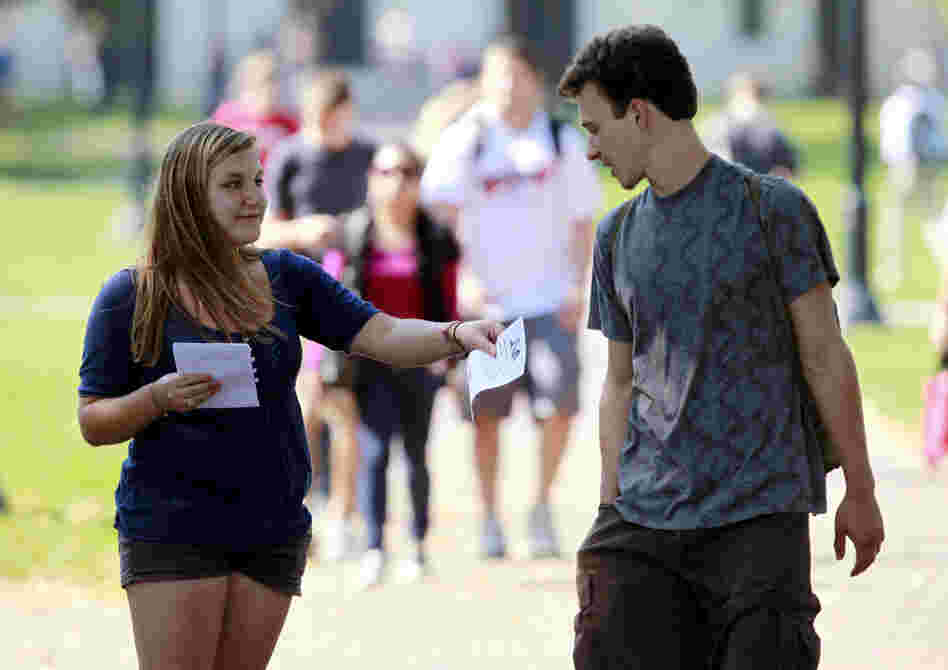 Genna Schwartz (left) of the Ohio State University Student Democrats tried to hand out information about President Obama's Oct. 17 visit to Ohio State and was turned down by a young man. The Obamamania that gripped college campuses two years ago is largely gone. 