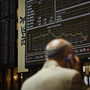 A broker uses a phone in front of the main screen at the Stock Exchange in Madrid, Spain. The country's central bank recently warned of "troubled exposure" to real estate, heightening fears about the stability of Spain's banks. A broker uses a phone in front of the main screen at the Stock Exchange in Madrid, Spain. The country's central bank recently warned of "troubled exposure" to real estate, heightening fears about the stability of Spain's banks.