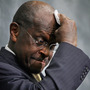 Republican presidential hopeful Herman Cain wipes his brow during a discussion on health care Wednesday in Washington. The former head of the National Restaurant Association has been under fire in recent days over sexual harassment allegations and his response to them. 