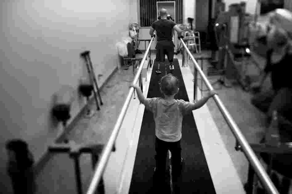 Liam, 2, accompanies his dad during rehab at the Naval Medical Center.
