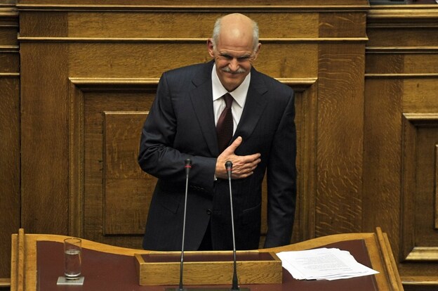 Greek Prime Minister George Papandreou greets members of parliament at the end of his speech during a debate on the confidence vote at the Greek Parliament in Athens.