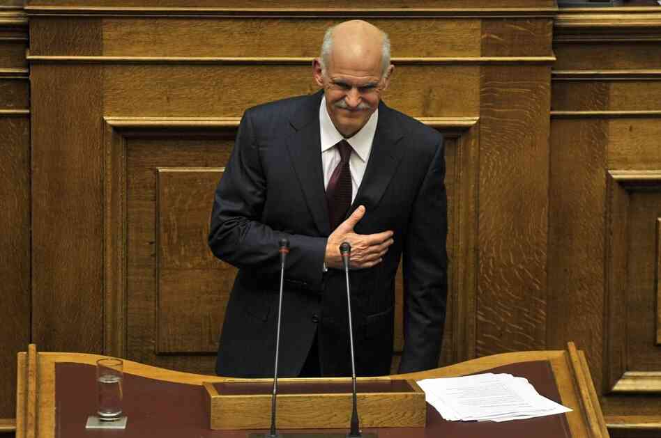 Greek Prime Minister George Papandreou greets members of parliament at the end of his speech during a debate on the confidence vote at the Greek Parliament in Athens.