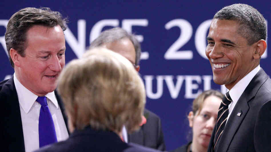 British Prime Minister David Cameron (left) speaks with German Chancellor Angela Merkel and President Obama at the G-20 summit Friday in Cannes, France. British Prime Minister David Cameron (left) speaks with German Chancellor Angela Merkel and President Obama at the G-20 summit Friday in Cannes, France.
