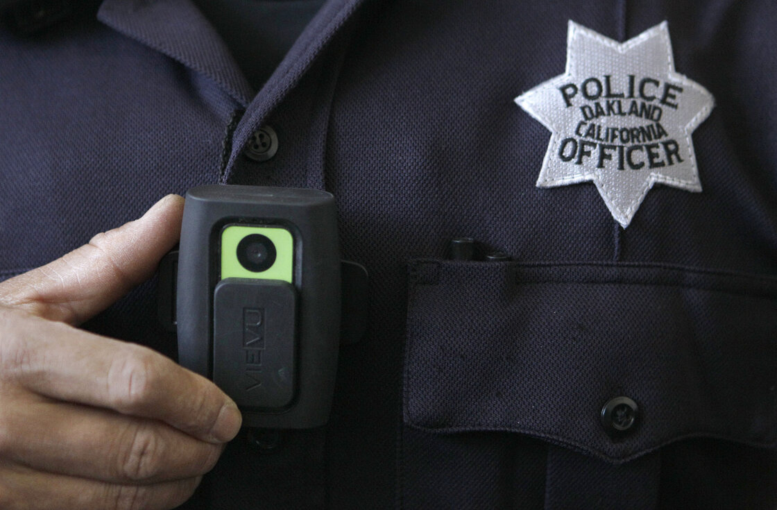 Officer Huy Nguyen shows a video camera worn by some officers in Oakland, Calif. Oakland and dozens of other police departments across the country are equipping officers with tiny body cameras to record anything from a traffic stop to a violent crime in progress. Officer Huy Nguyen shows a video camera worn by some officers in Oakland, Calif. Oakland and dozens of other police departments across the country are equipping officers with tiny body cameras to record anything from a traffic stop to a violent crime in progress.