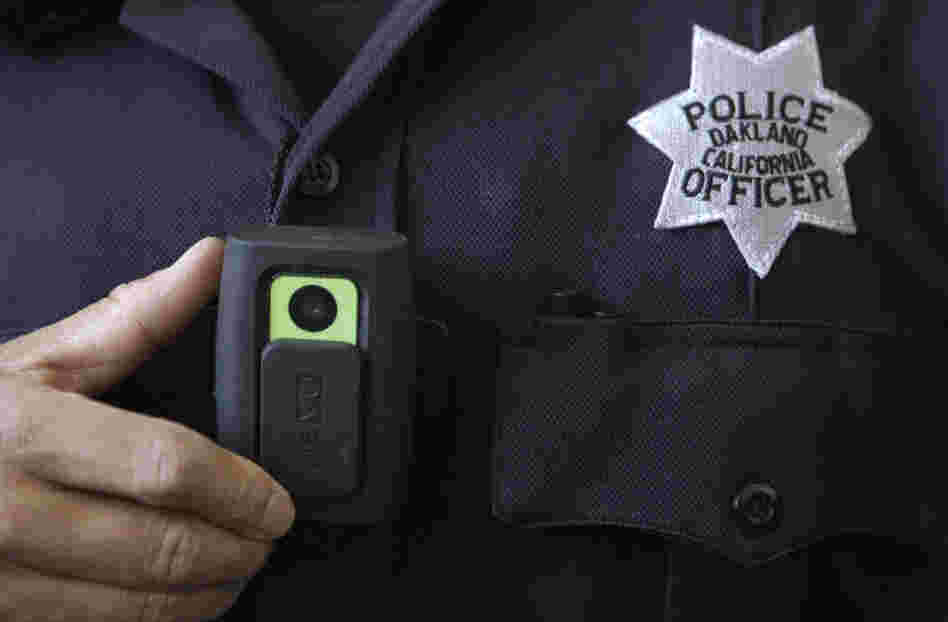 Officer Huy Nguyen shows a video camera worn by some officers in Oakland, Calif. Oakland and dozens of other police departments across the country are equipping officers with tiny body cameras to record anything from a traffic stop to a violent crime in progress. Officer Huy Nguyen shows a video camera worn by some officers in Oakland, Calif. Oakland and dozens of other police departments across the country are equipping officers with tiny body cameras to record anything from a traffic stop to a violent crime in progress.