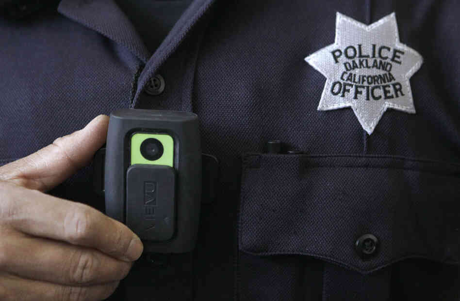 Officer Huy Nguyen shows a video camera worn by some officers in Oakland, Calif. Oakland and dozens of other police departments across the country are equipping officers with tiny body cameras to record anything from a traffic stop to a violent crime in progress. Officer Huy Nguyen shows a video camera worn by some officers in Oakland, Calif. Oakland and dozens of other police departments across the country are equipping officers with tiny body cameras to record anything from a traffic stop to a violent crime in progress.