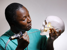 Striking a pose like Hamlet, Kofi Boahene, a surgeon at Johns Hopkins Hospital, peers through the natural opening under the cheekbone and above the jaw that he uses for surgery. Striking a pose like Hamlet, Kofi Boahene, a surgeon at Johns Hopkins Hospital, peers through the natural opening under the cheekbone and above the jaw that he uses for surgery.