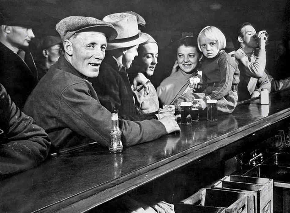 One of the photos from Margaret Bourke-White's cover story in the first issue of Life: Residents of a Fort Peck gather at a saloon. One of the photos from Margaret Bourke-White's cover story in the first issue of Life: Residents of a Fort Peck gather at a saloon.