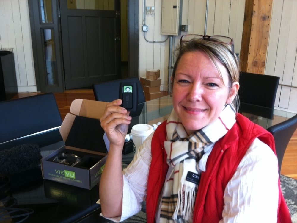 Heidi Traverso, director of business development at Vievu in Seattle, holds the company's pager-sized video camera, designed to be worn on a police officer's uniform. The officer activates the camera by sliding open the protective cover. It can record for up to four hours.