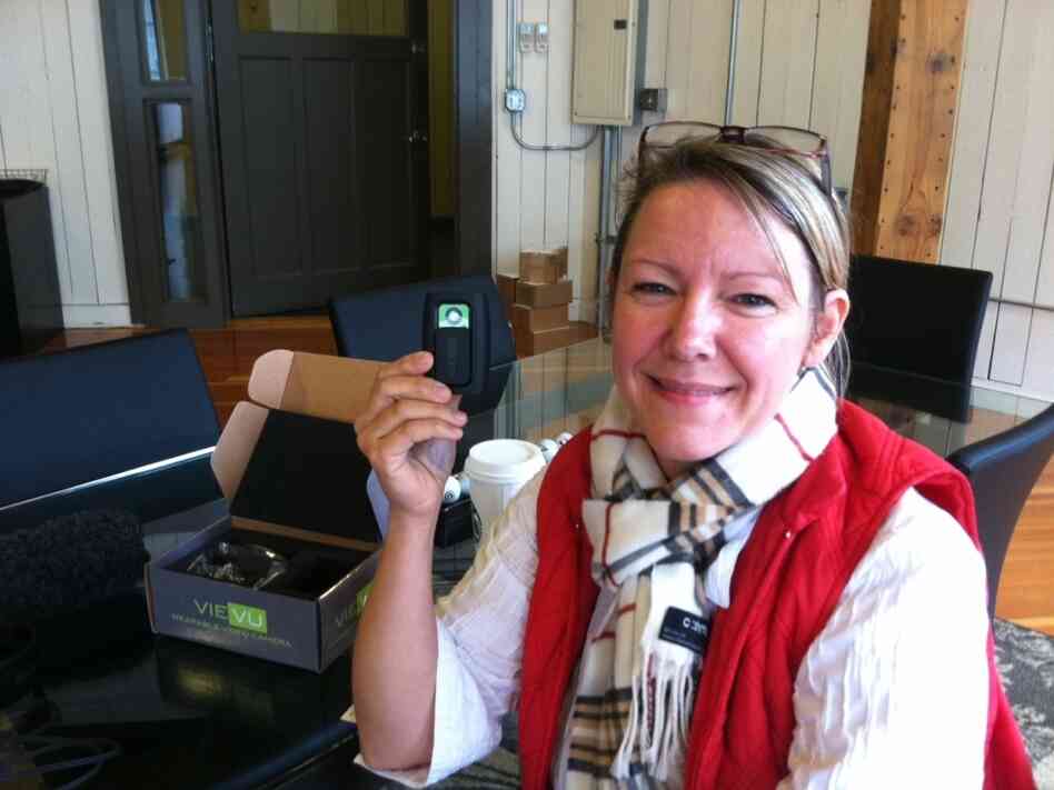 Heidi Traverso, director of business development at Vievu in Seattle, holds the company's pager-sized video camera, designed to be worn on a police officer's uniform. The officer activates the camera by sliding open the protective cover. It can record for up to four hours.