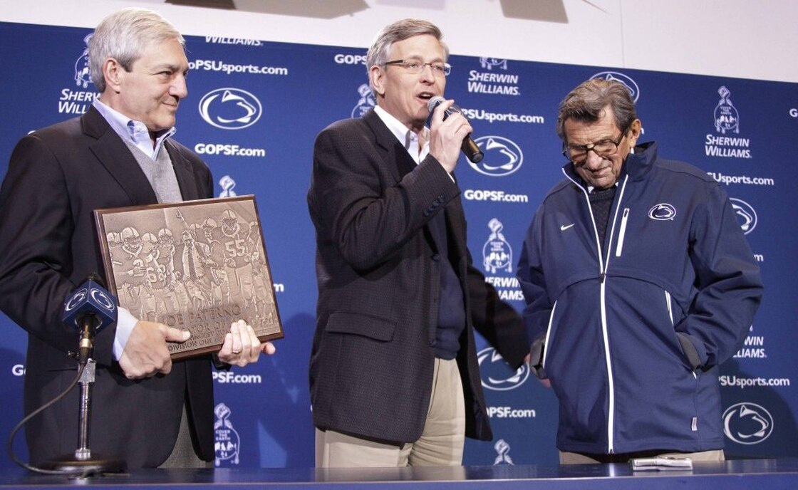 Penn State Athletic Director Tim Curley (center), pictured with head football coach Joe Paterno (right) and university President Graham Spanier, is expected to turn himself in Monday in Harrisburg, Pa.