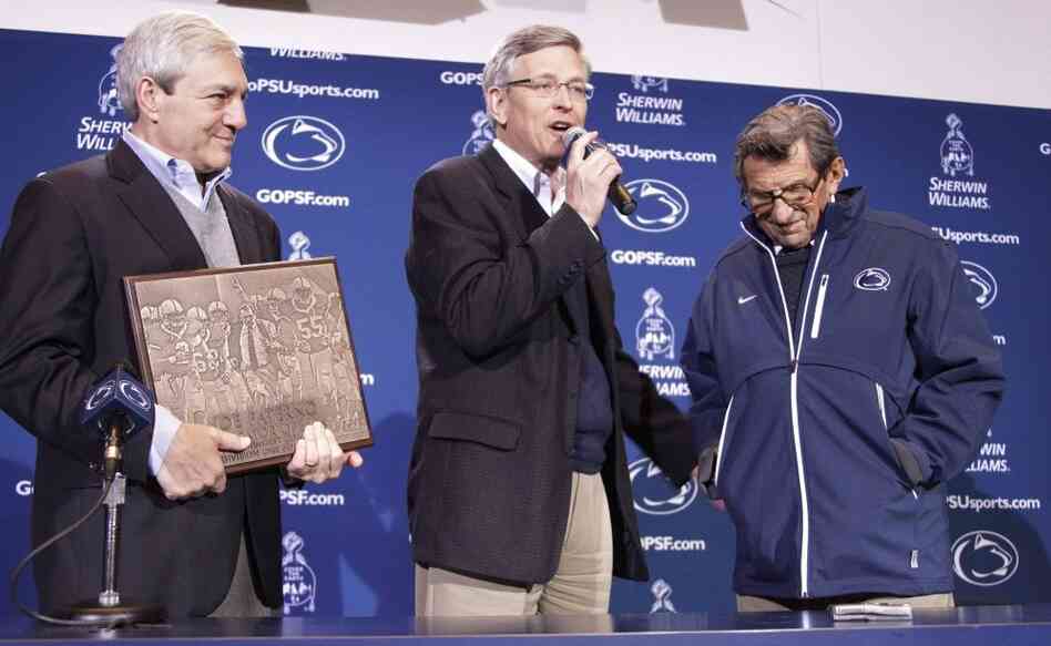 Penn State Athletic Director Tim Curley (center), pictured with head football coach Joe Paterno (right) and university President Graham Spanier, is expected to turn himself in Monday in Harrisburg, Pa.