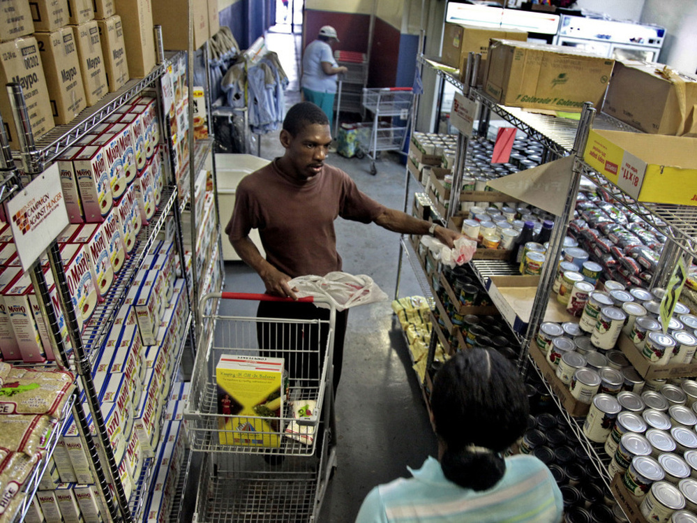Joseph Byrd, unemployed and living on disability, prepares to pick up groceries at the Bed-Stuy Campaign Against Hunger food pantry in Brooklyn, N.Y., in 2010. The new experimental poverty measure takes into account cost of living associated with geographic differences.