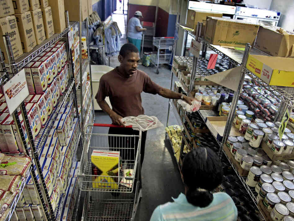 Joseph Byrd, unemployed and living on disability, prepares to pick up groceries at the Bed-Stuy Campaign Against Hunger food pantry in Brooklyn, N.Y., in 2010. The new experimental poverty measure takes into account cost of living associated with geographic differences.