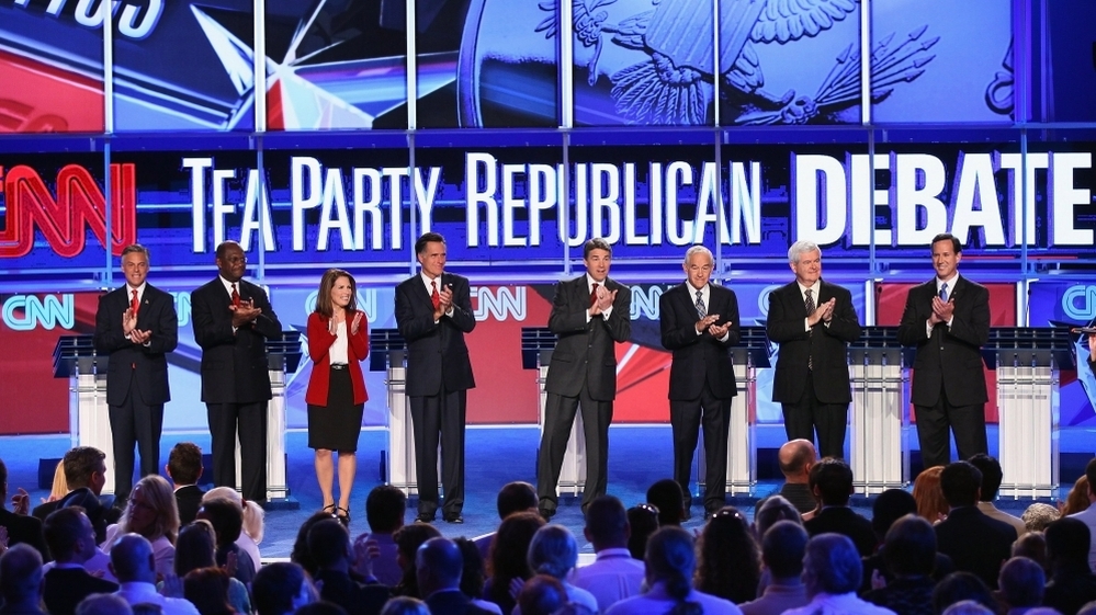 Republican presidential candidates (from left) Jon Huntsman, Herman Cain, Rep. Michele Bachmann, Mitt Romney, Gov. Rick Perry, Rep. Ron Paul, Newt Gingrich and Rick Santorum prepare to debate during the event sponsored by CNN and the Tea Party Express at the Florida state fairgrounds on Sept. 12 in Tampa.