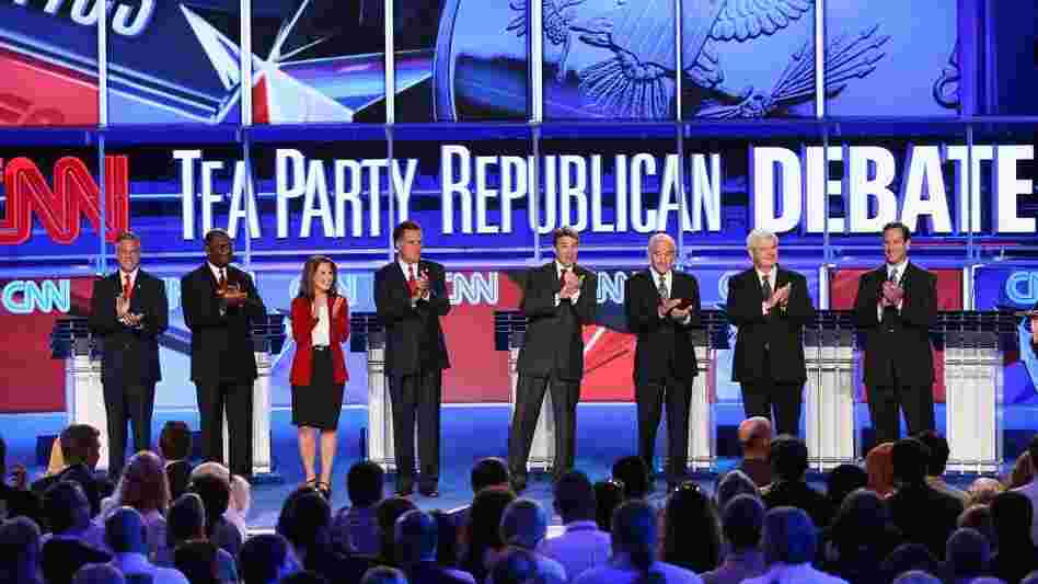 Republican presidential candidates (from left) Jon Huntsman, Herman Cain, Rep. Michele Bachmann, Mitt Romney, Gov. Rick Perry, Rep. Ron Paul, Newt Gingrich and Rick Santorum prepare to debate during the event sponsored by CNN and the Tea Party Express at the Florida state fairgrounds on Sept. 12 in Tampa.