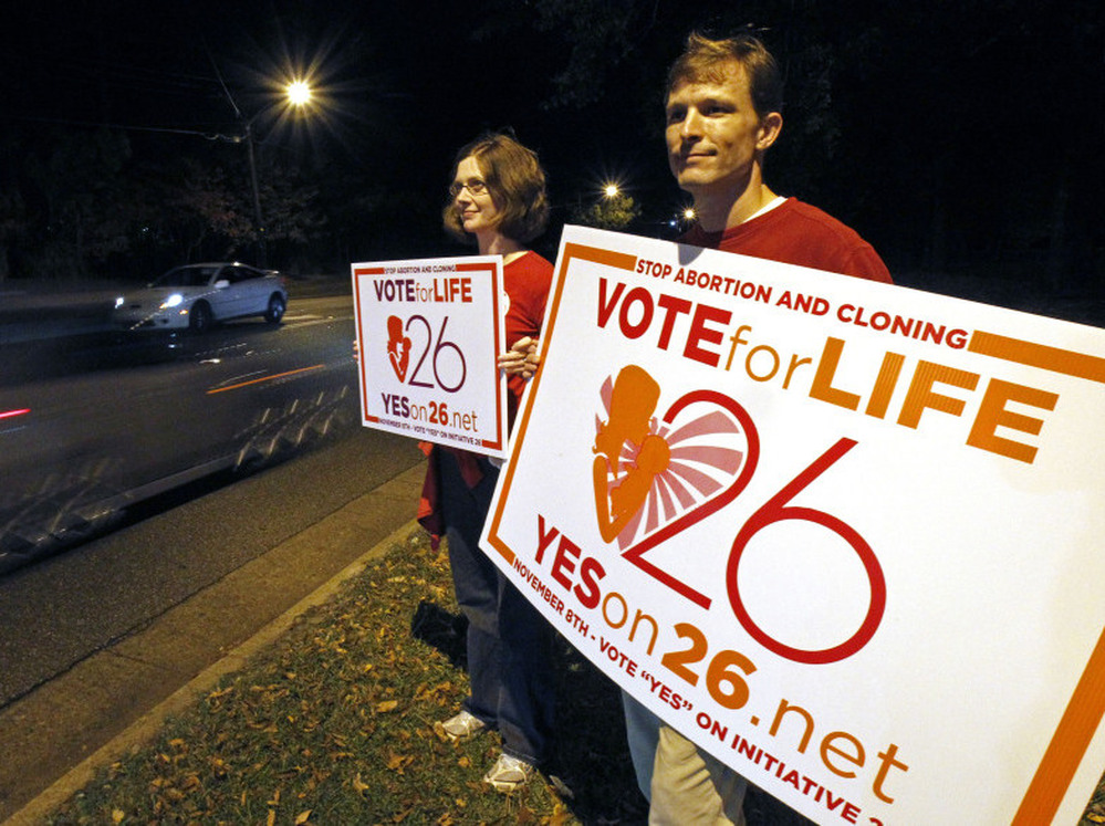 Adam Browne, right and wife Debbie show support for the Mississippi "personhood" amendment,Tuesday, Nov. 8, 2011 in Jackson, Miss. 
