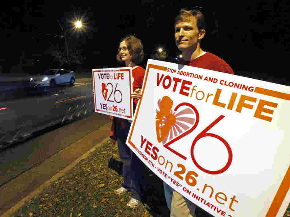 Adam Browne, right and wife Debbie show support for the Mississippi "personhood" amendment,Tuesday, Nov. 8, 2011 in Jackson, Miss. 