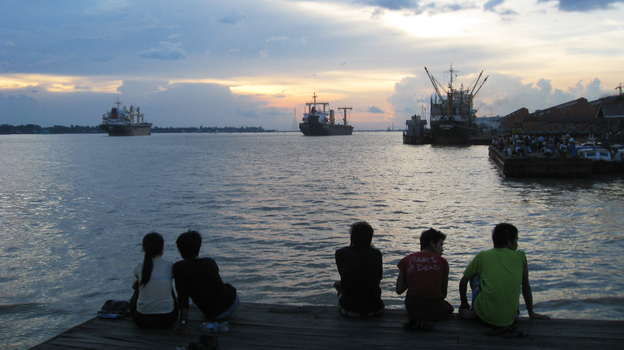 Yangon residents enjoy the sunset on the city's river. For decades, the Southeast Asian nation of Myanmar has suffered under a repressive military rule. But a new government installed in March says it's sincere about reform. 