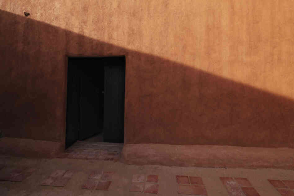 The door in the adobe patio wall is what first attracted Georgia O'Keeffe to this house in Abiquiu, N.M.