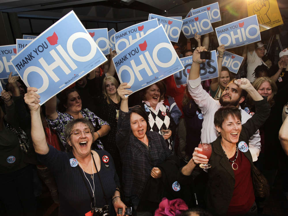 Opponents of a law limiting collective-bargaining rights cheer in Cleveland as they hear election results sounding the defeat of the measure in the Ohio general election on Tuesday.