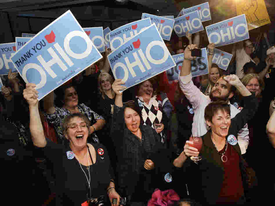 Opponents of a law limiting collective-bargaining rights cheer in Cleveland as they hear election results sounding the defeat of the measure in the Ohio general election on Tuesday.