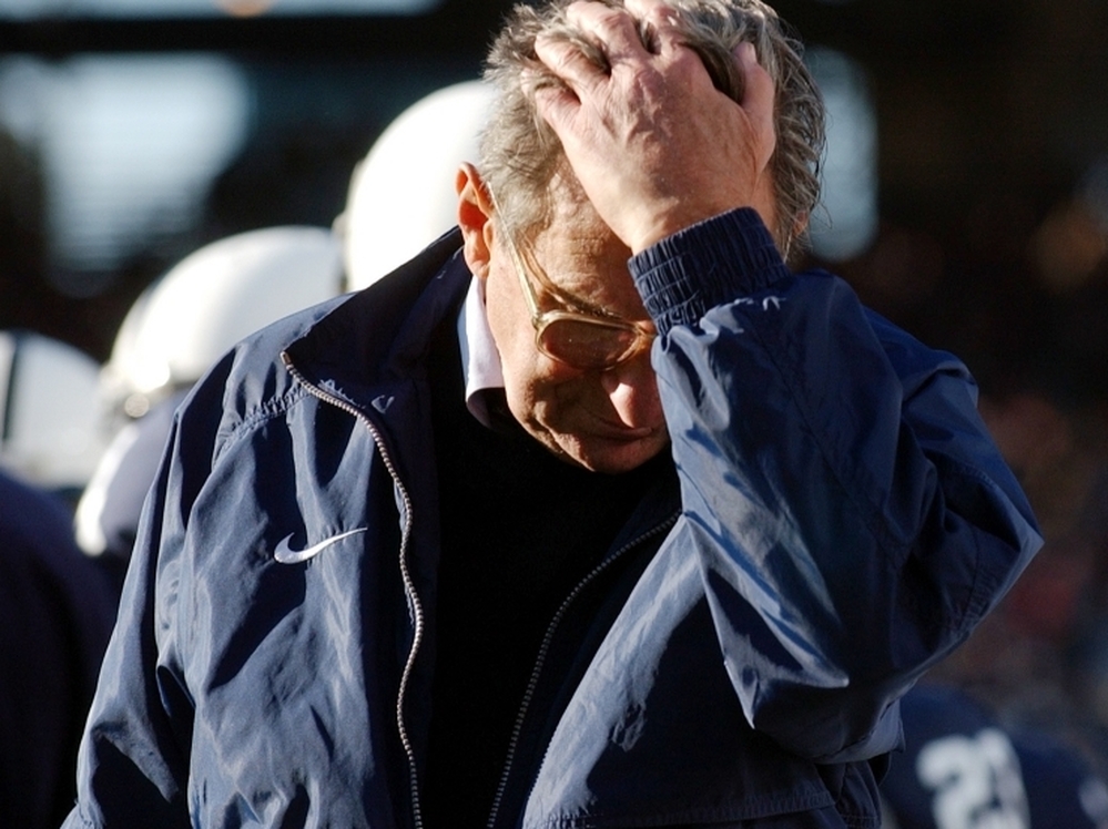 Penn State football coach Joe Paterno pauses on the sidelines during a game against Northwestern. Paterno's former assistant coach Jerry Sandusky has been accused of sexual abuse. 
