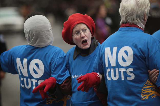 Judy Moses, 71, prepares to be arrested during an Occupy Chicago protest against cuts to federal safety net programs, including Social Security, Medicare and Medicaid, on Monday.